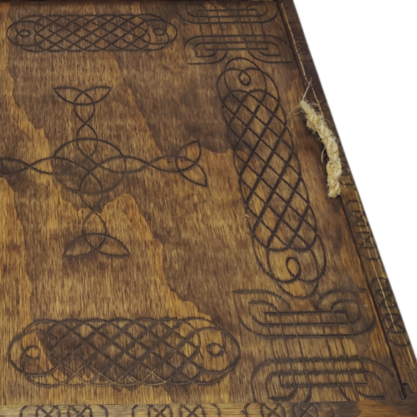 Puzzle board engraved with Celtic knotwork and fitted with a rope handle